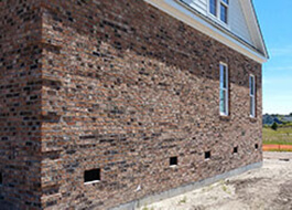 side of house with brown bricks from additional services