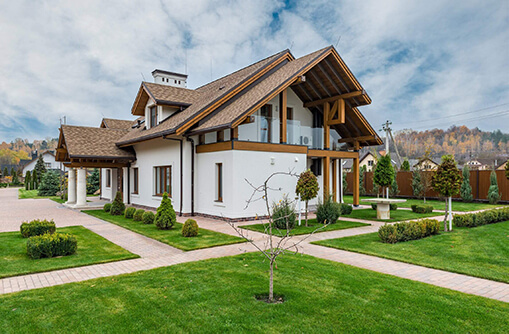white residential villa on green grass with custom roof design norfolk